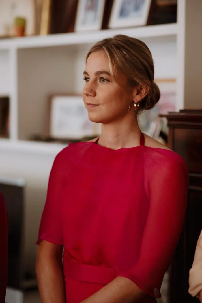 Invitada preparada con vestido rojo y peinado de evento.