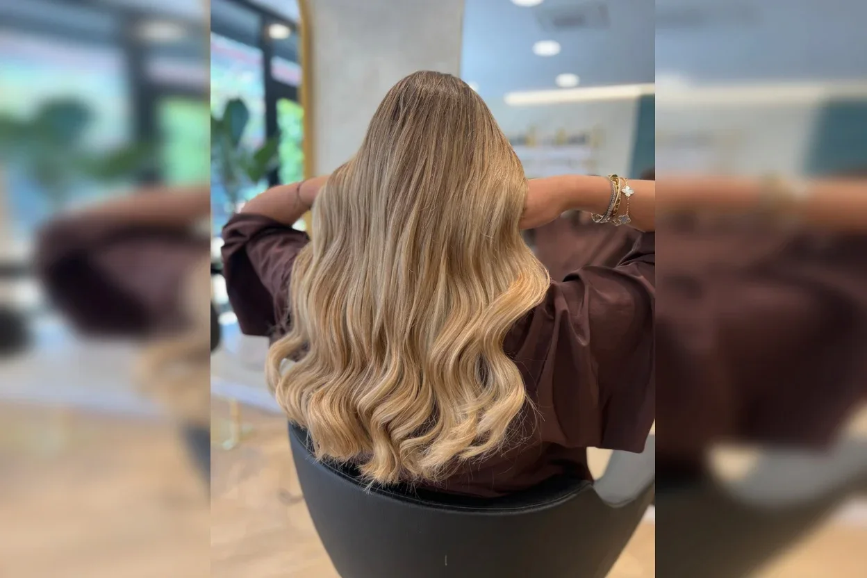 Wavy blonde hair viewed from behind.